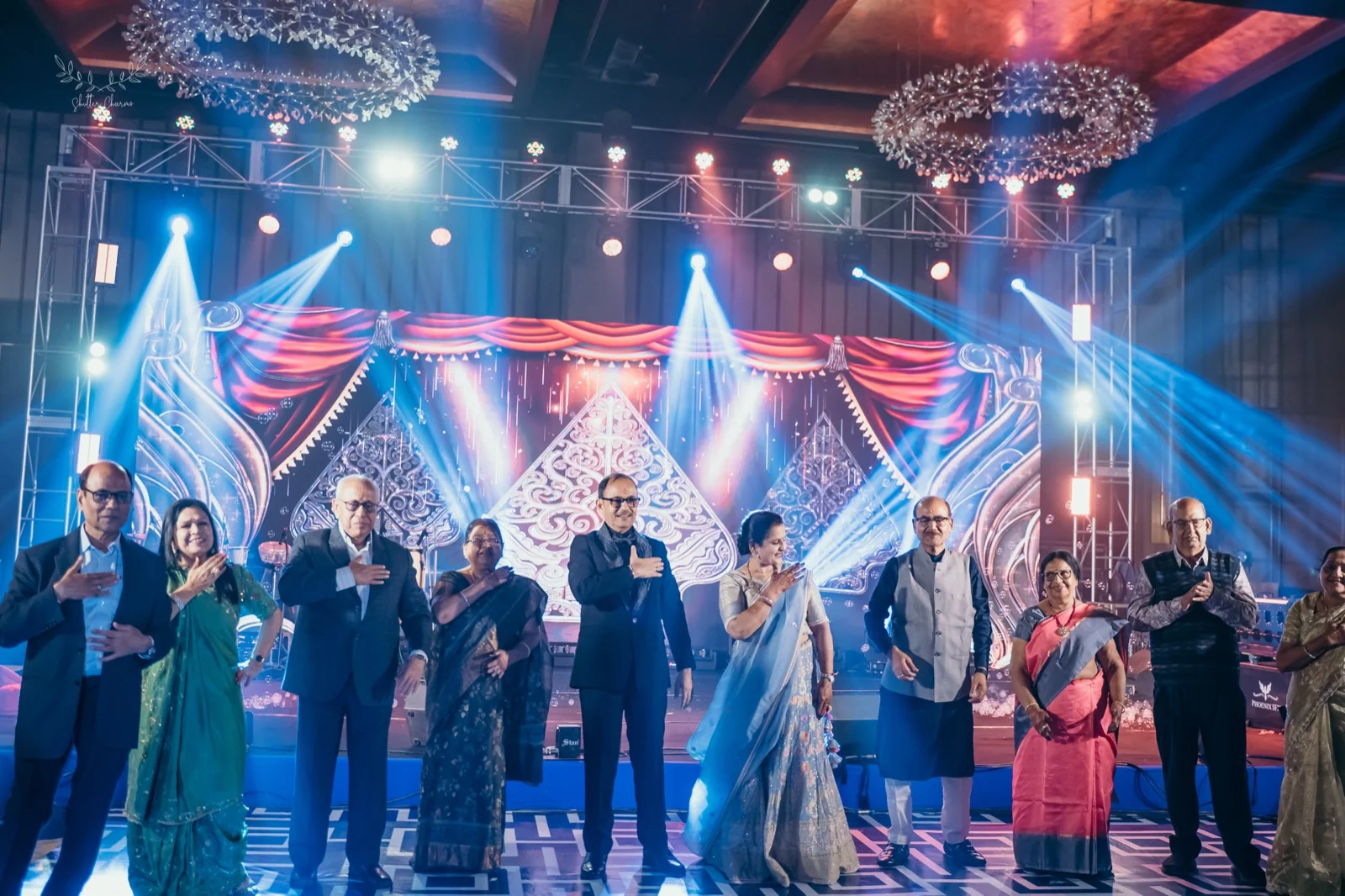 Family members perform a group dance on the sangeet stage