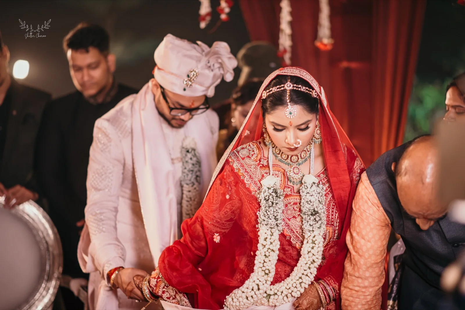 Bride and groom with jasmine garlands during mandap wedding rituals