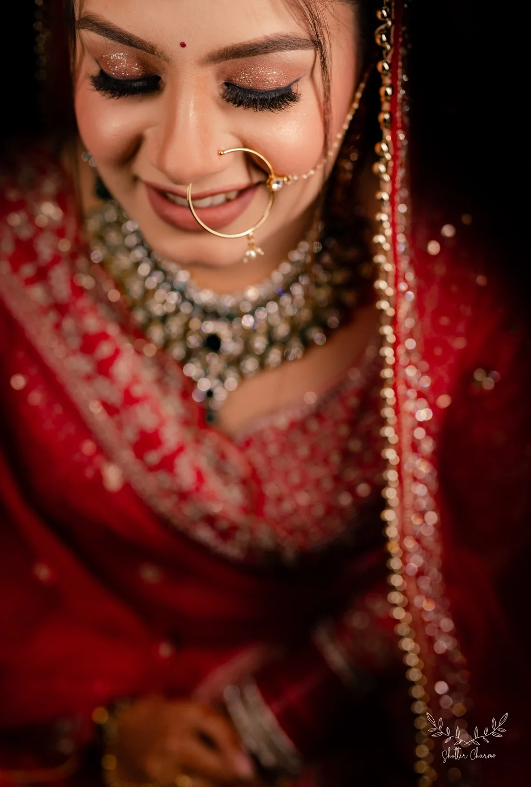 Close-up of smiling bride with gold nath and bridal jewellery