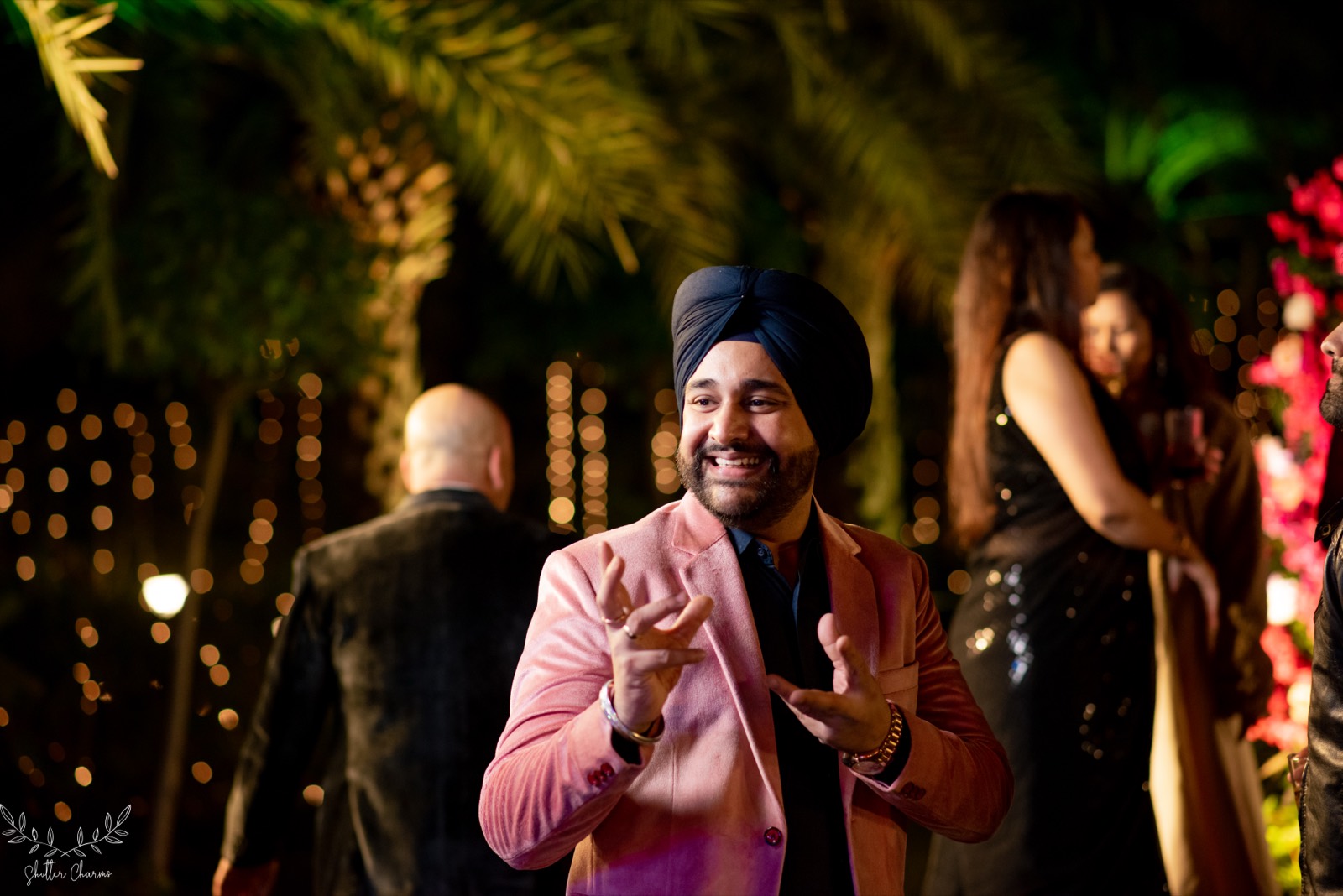 Guest in pink blazer enjoying the evening wedding festivities