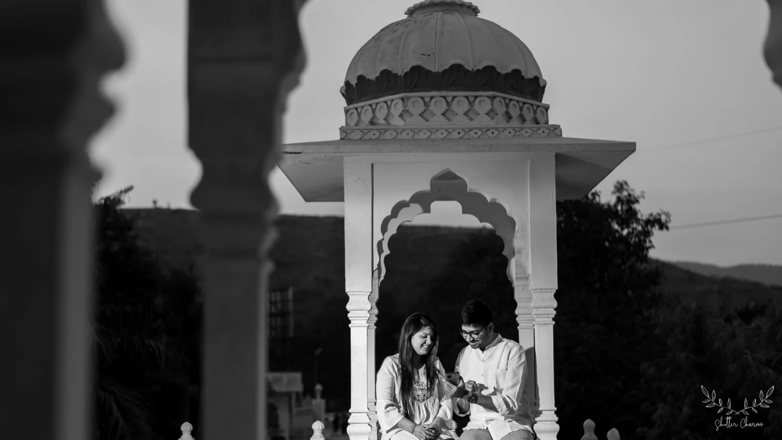 Couple sharing a quiet moment in a heritage stone pavilion