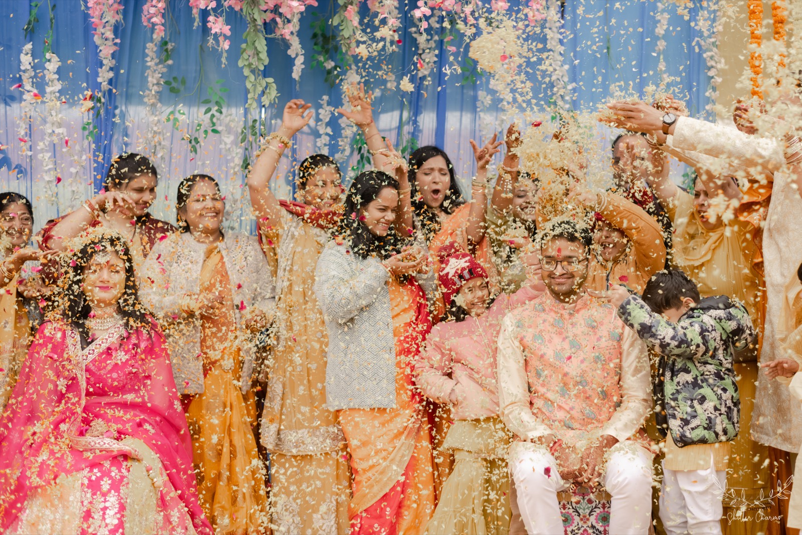 Guests showering flower petals over the smiling couple in celebration