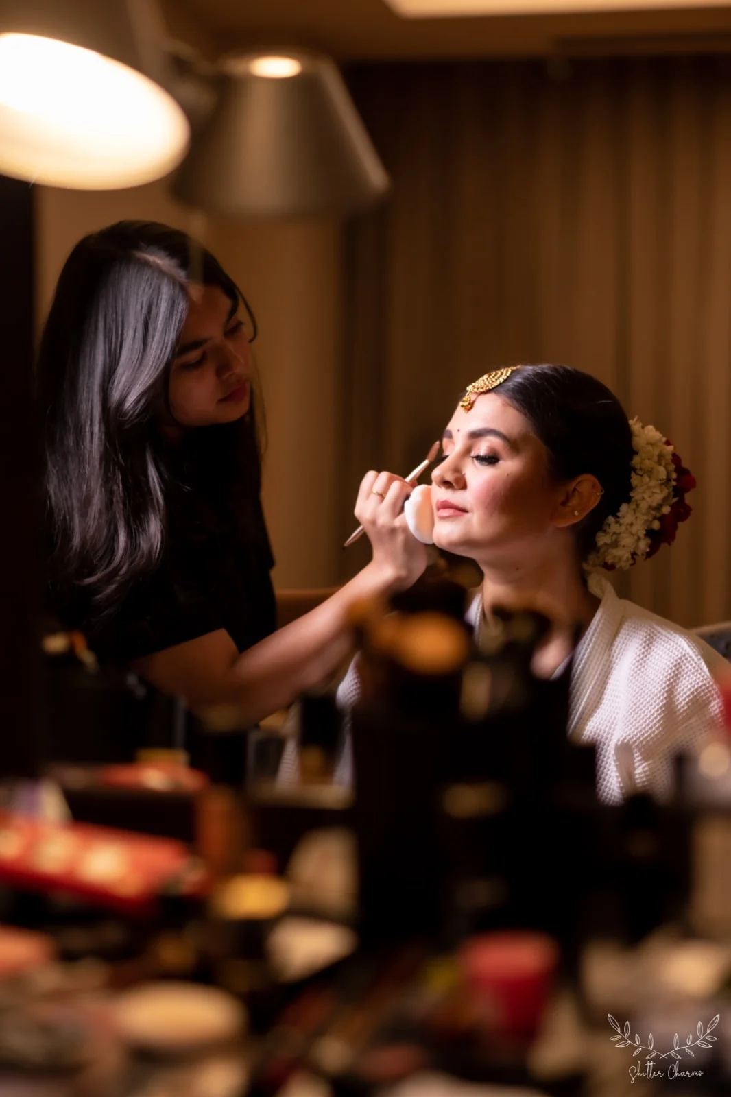 Makeup artist preparing the bride during her getting-ready session