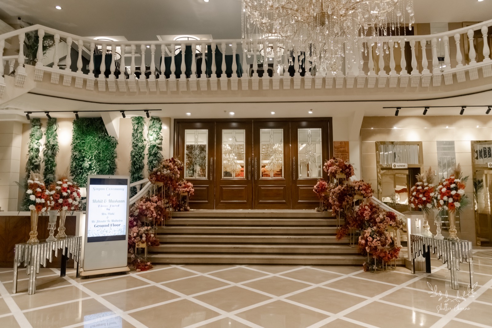 Flower-lined venue entrance with welcome signage for the sagan ceremony