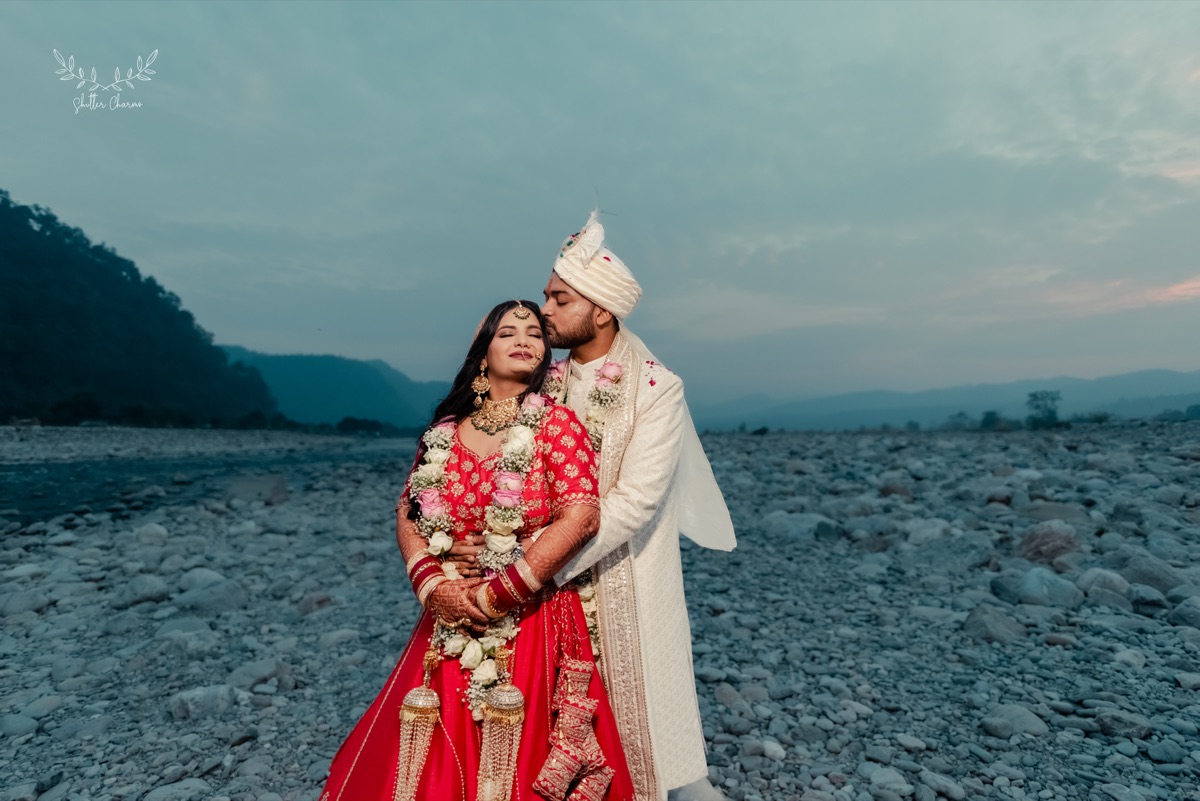 Couple embracing on a riverbed at dusk