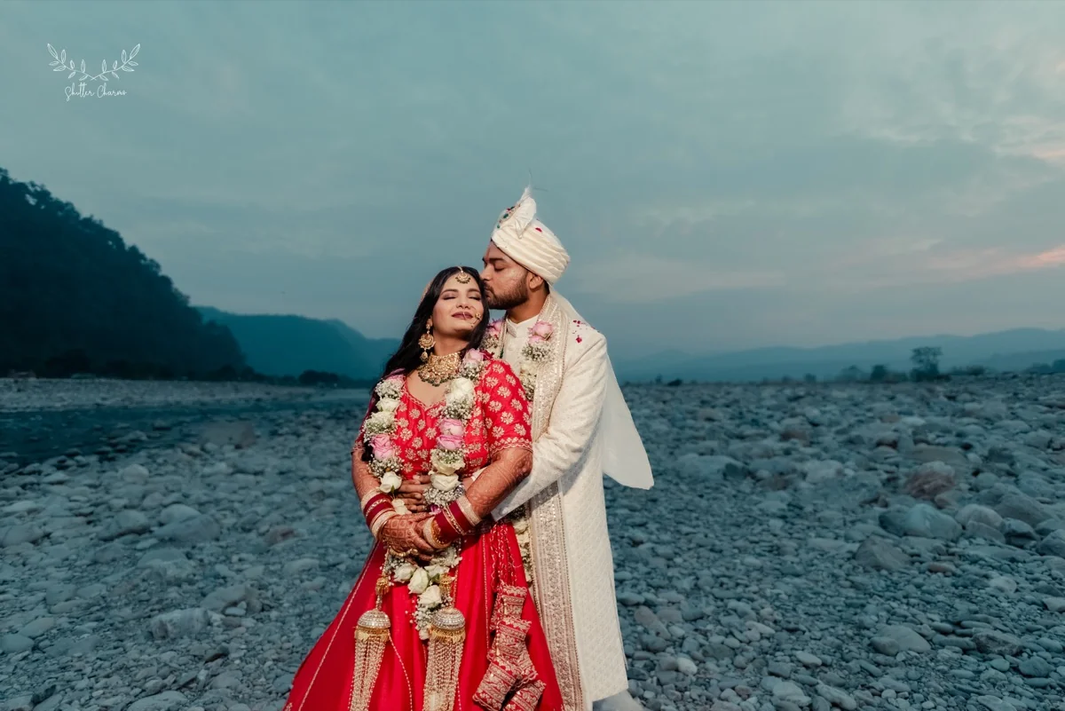Couple embracing on a riverbed at dusk